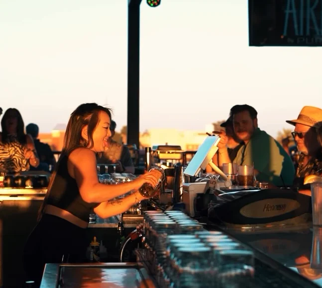 AIRE bartender preparing drinks in the sunset